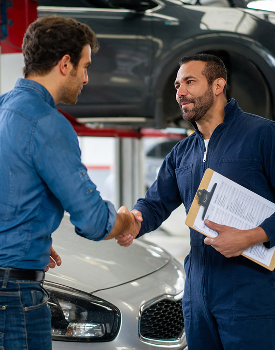 man greeting a mechanic with a handshake