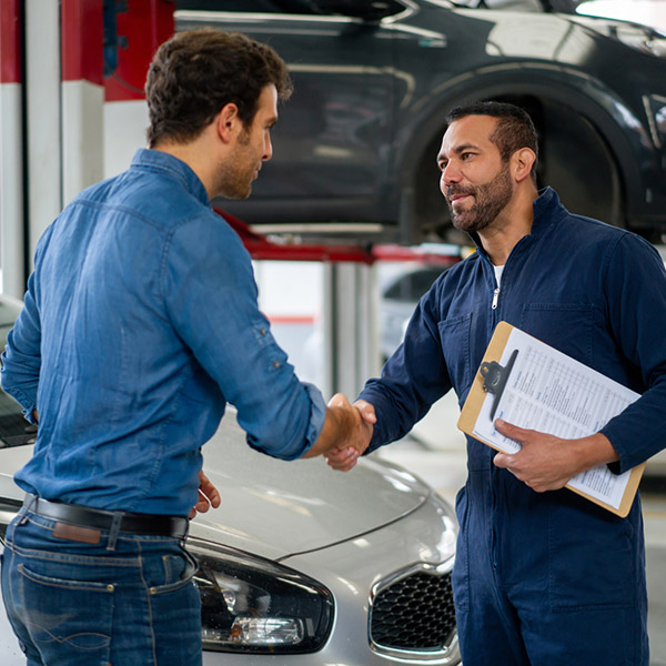 man greeting a mechanic with a handshake